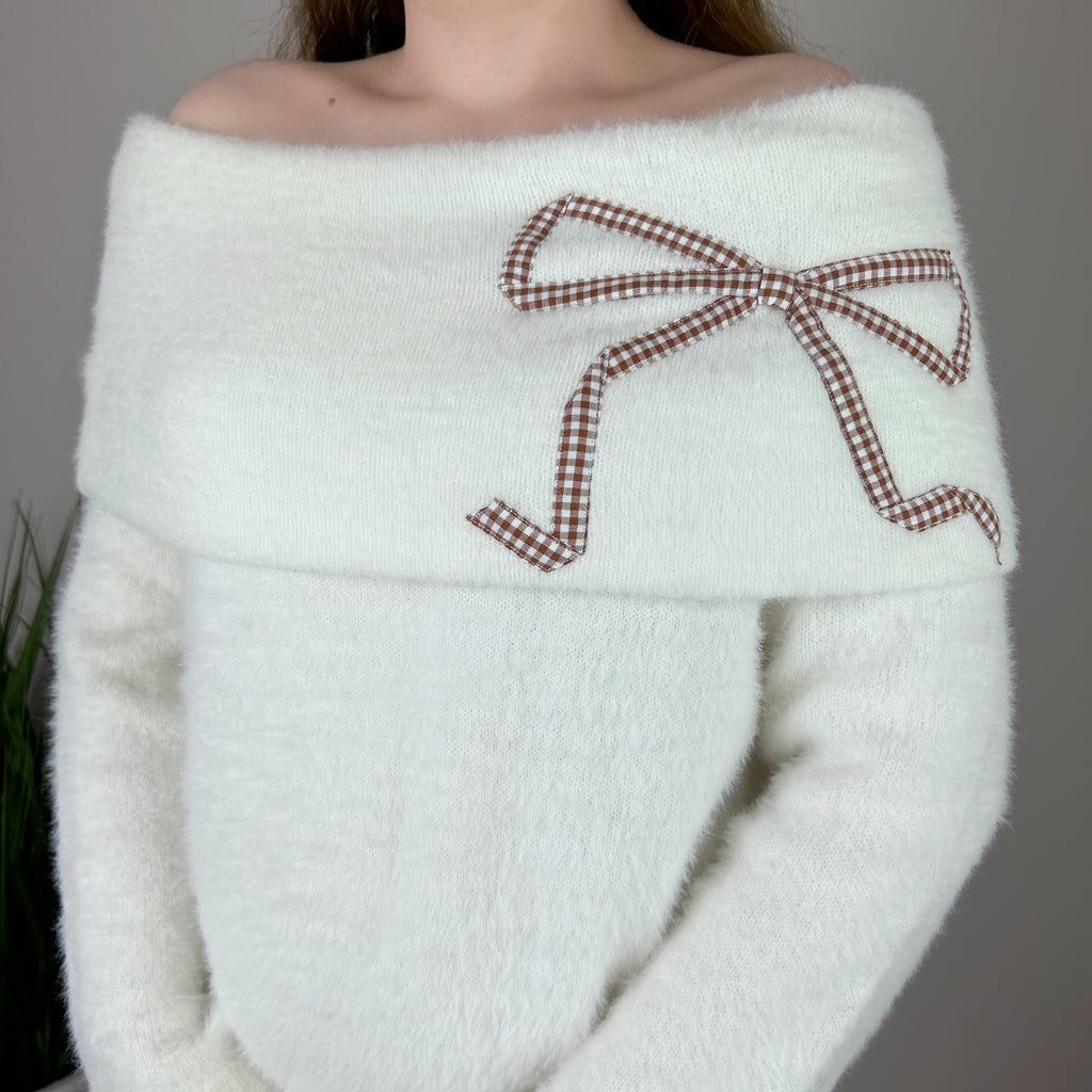 Sweater with clearance bow on shoulder